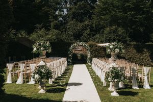 Outdoor garden wedding ceremony setup with white chairs arranged in rows at Saltmarshe Hall - taken by Grimsby photographer.