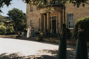 Bride and groom stood outside Saltmarshe Hall on a warm sunny day - taken by Grimsby photographer.