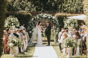 A romantic outdoor wedding ceremony under a floral arch at Saltmarshe Hall - taken by Grimsby photographer.