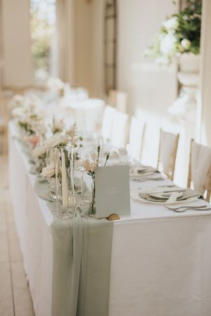 Elegant white wedding reception tables set with fresh floral centrepieces and crisp linens at Saltmarshe Hall - by Grimsby photographers.