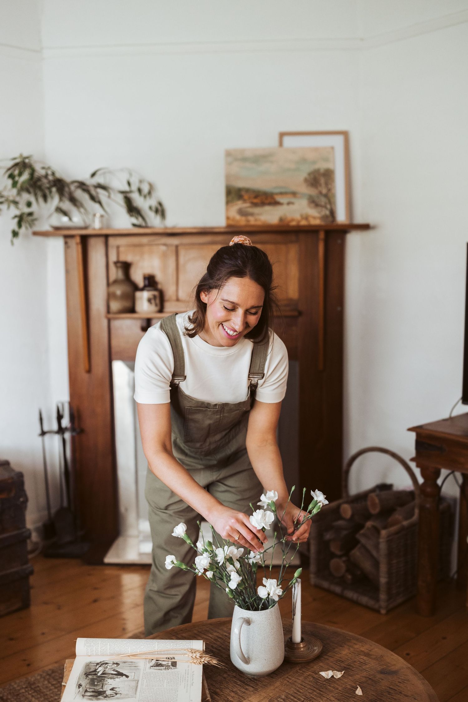 Female florist arranging white flowers in apron - authentic personal branding melbourne