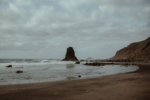 Dramatic seascape with large rock formations and cloudy skies at a moody beach. Playa de Benijo. Love Story in Tenerife.