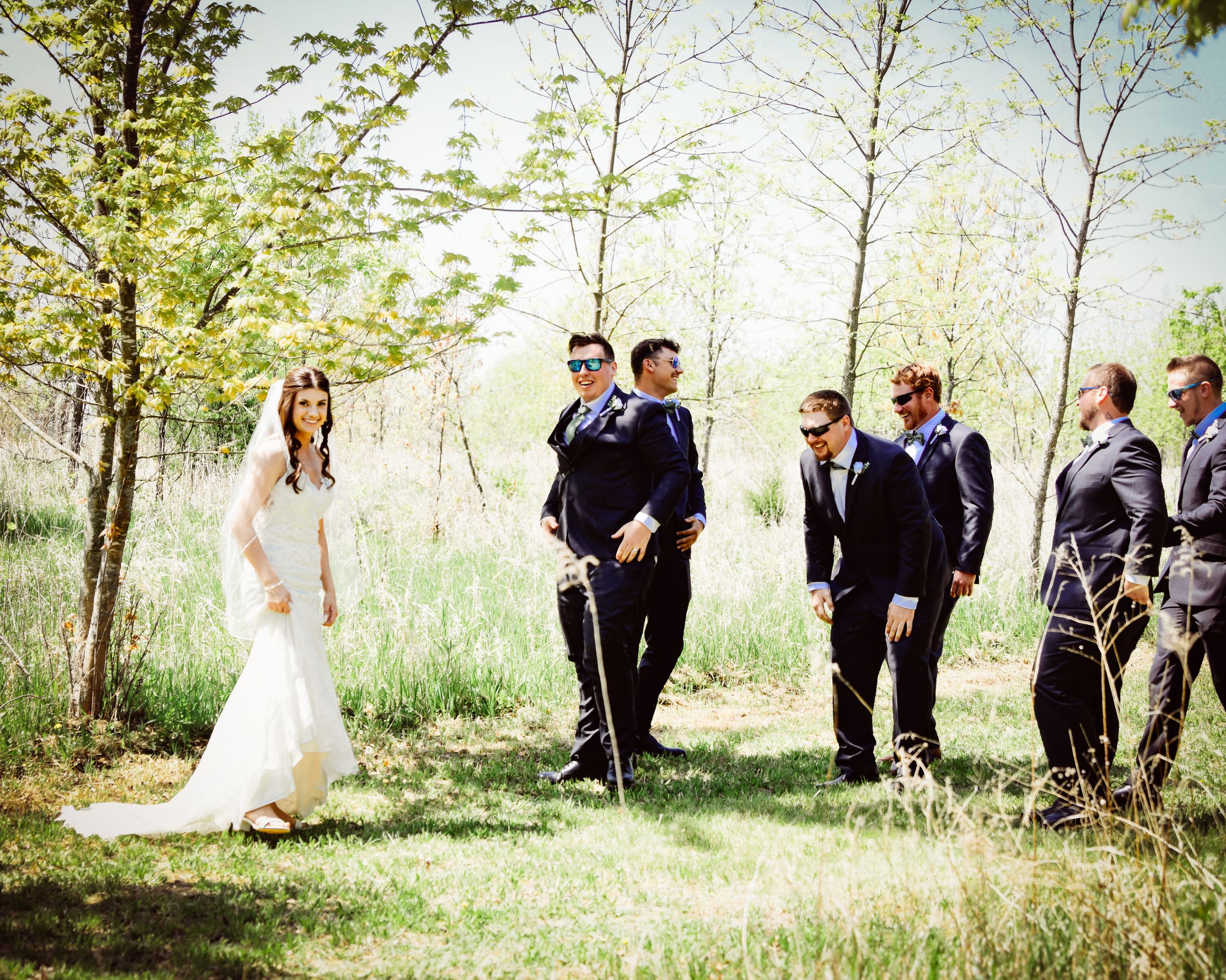 Candid moments of a wedding party enjoying themselves in a sunny outdoor setting.