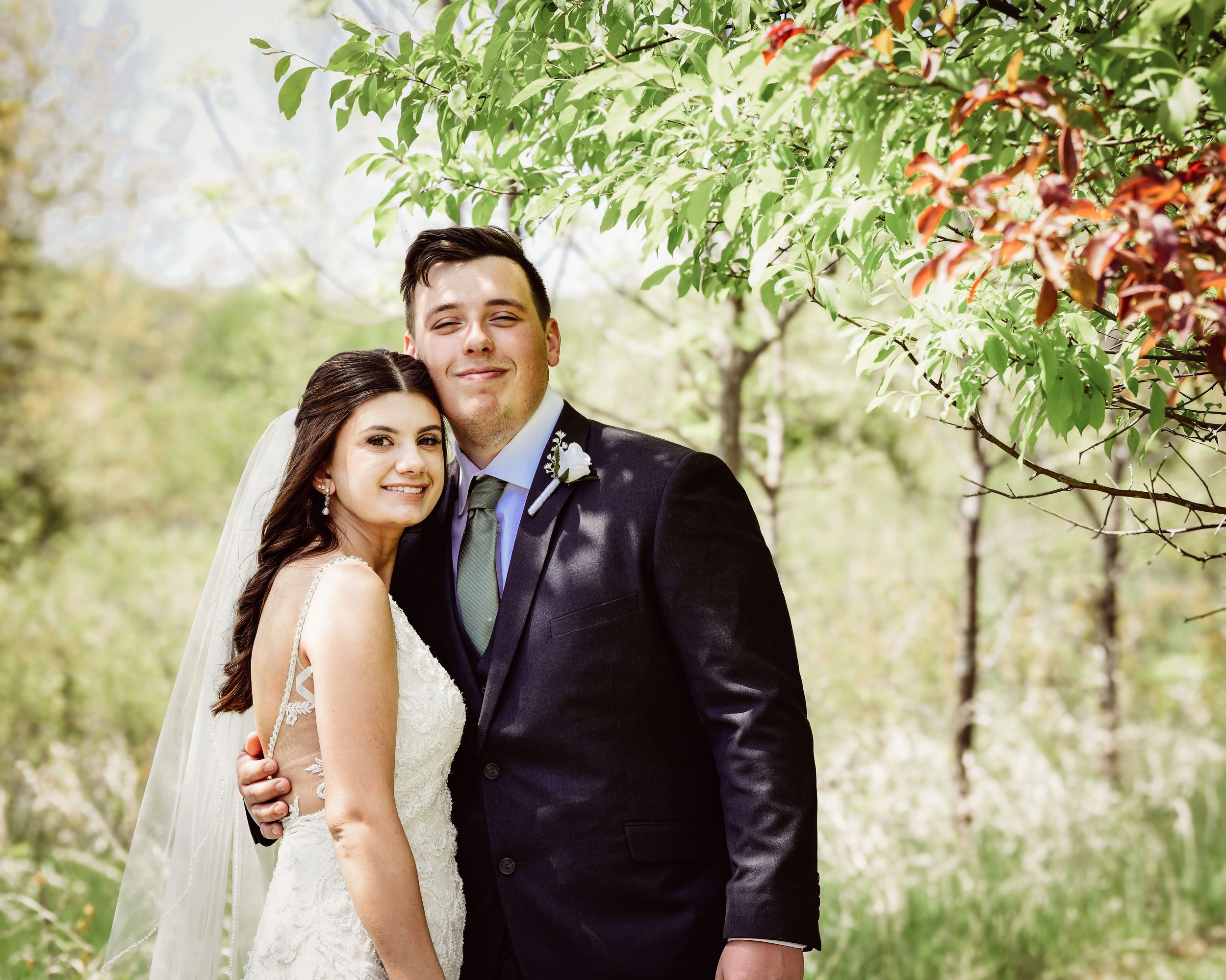 Wedding photo sequence showing couple's romantic moments among blooming trees.