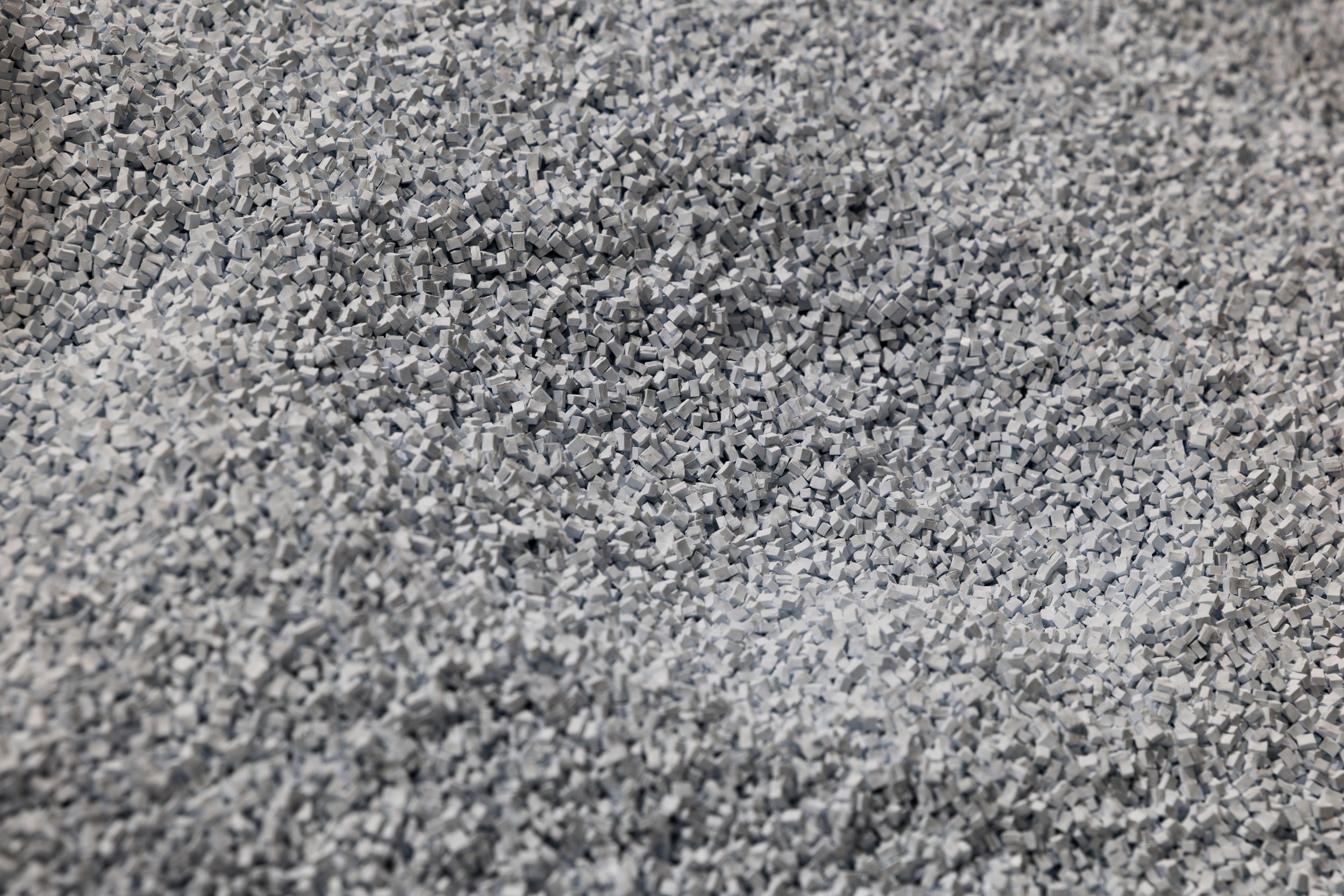 Close-up texture of fine gray sand or powder showing granular details and natural pattern.