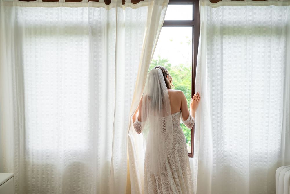A glowing curtain in a sunlit room creates a soft and ethereal atmosphere by the window.