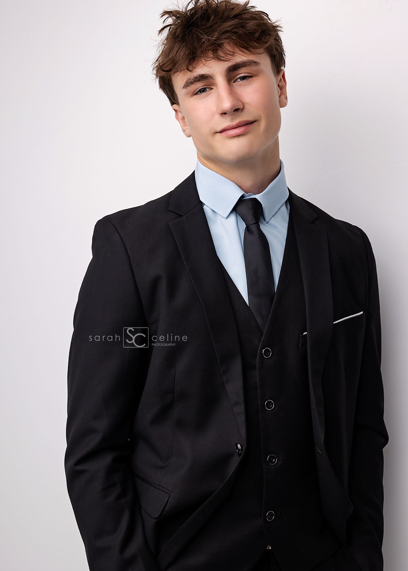 Professional headshot series featuring someone in a black suit and blue tie against a white backdrop.