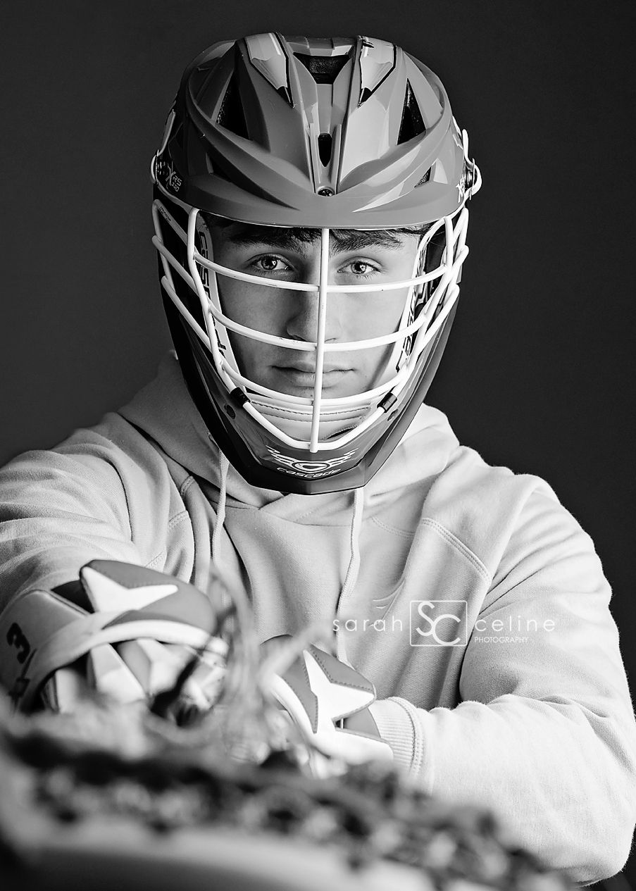 A black and white portrait series showing a lacrosse player in protective helmet and white uniform.