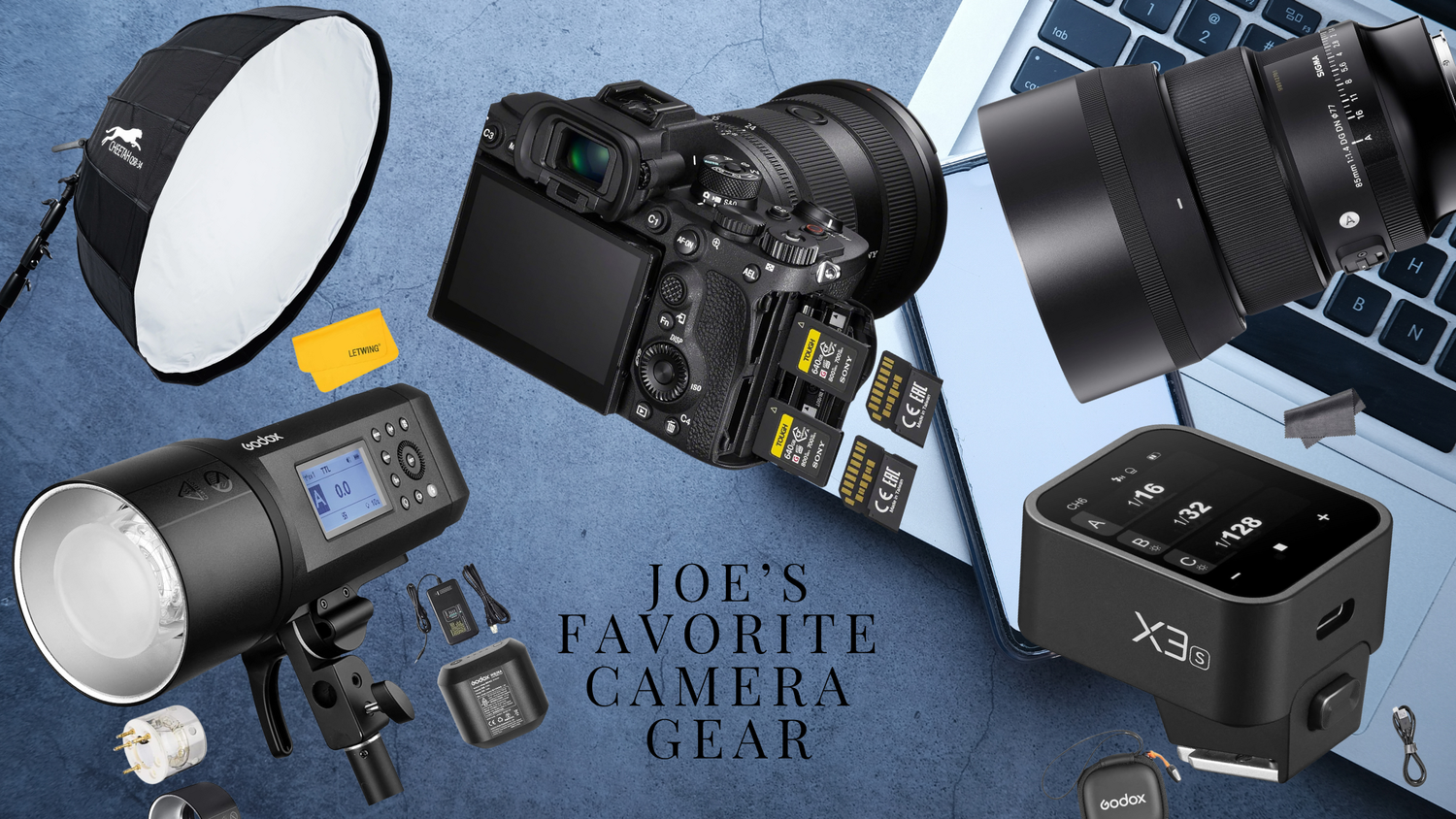 Professional photography equipment including camera body, lenses, flash units, and accessories laid out on gray background.