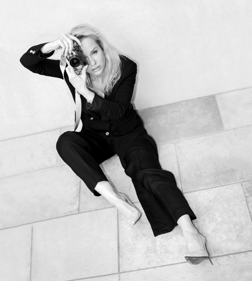 Monochrome  photo series showing a person in dark clothing posing dramatically against a light-colored wall.
Portrait of Angelina Bertrand