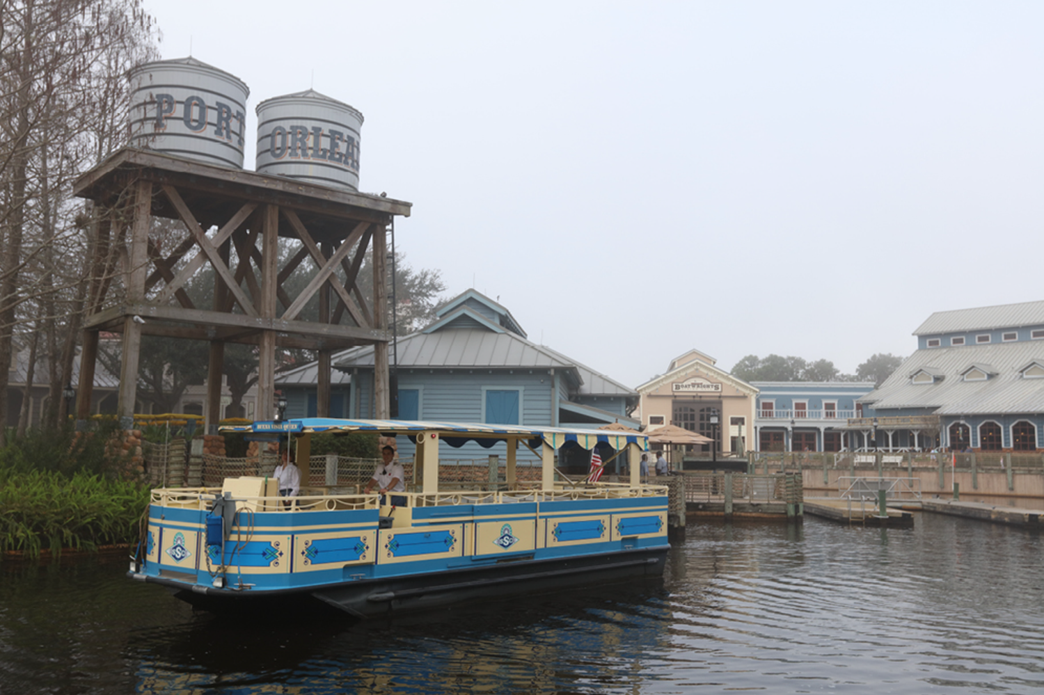 Panoramic view of Disney resort boat docks and waterfront buildings.