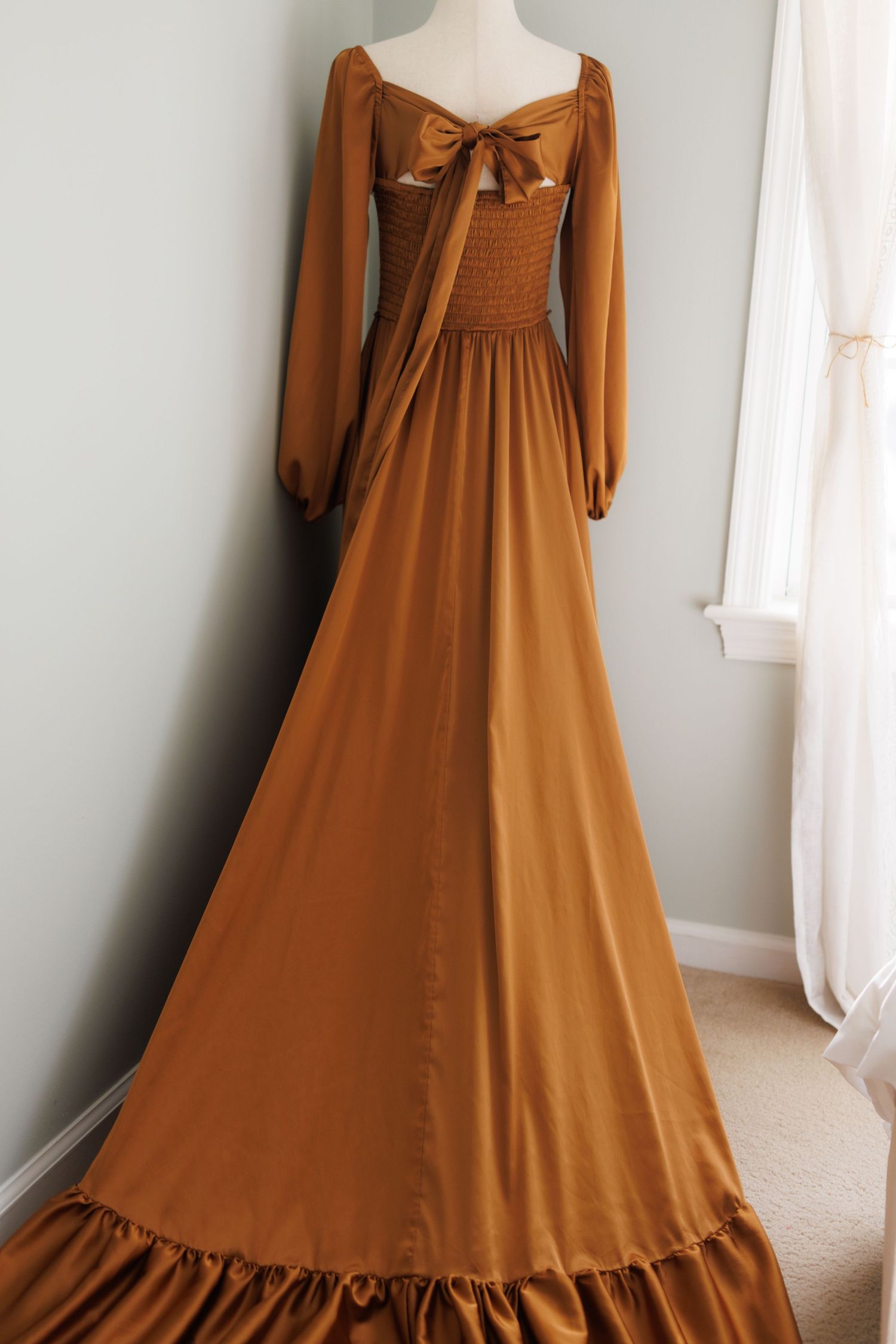 Vintage cream-colored peasant dress with puff sleeves and corset back lacing displayed on mannequin from multiple angles.