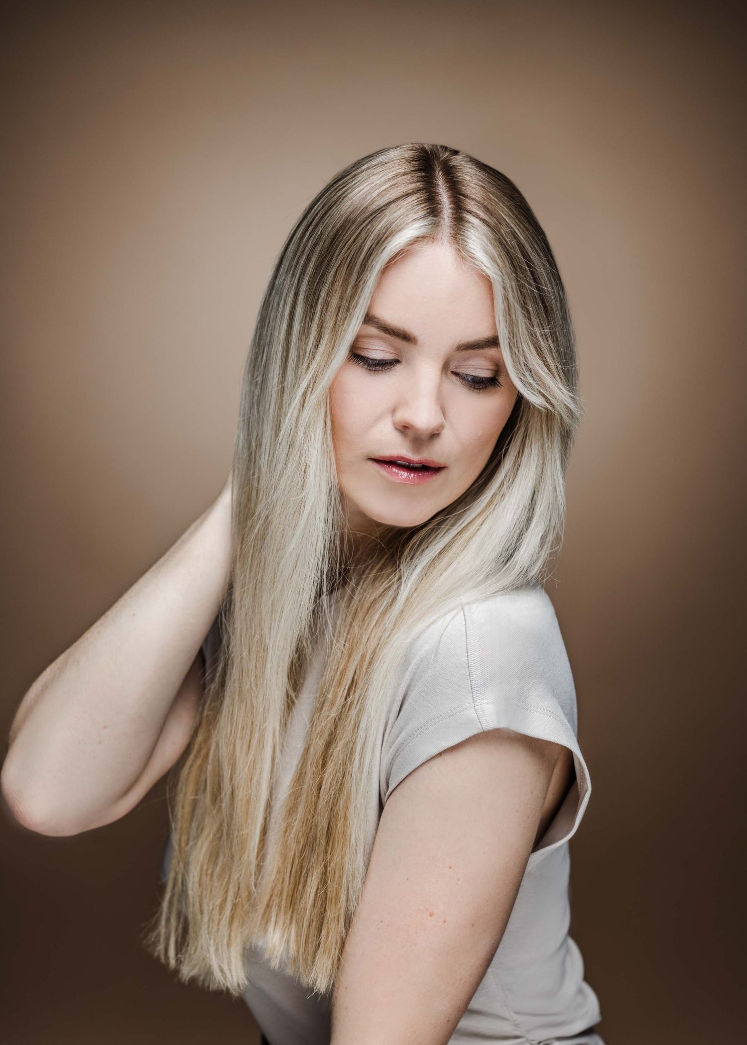 Artistic portrait series showing blonde hair and white top against brown background in various poses.