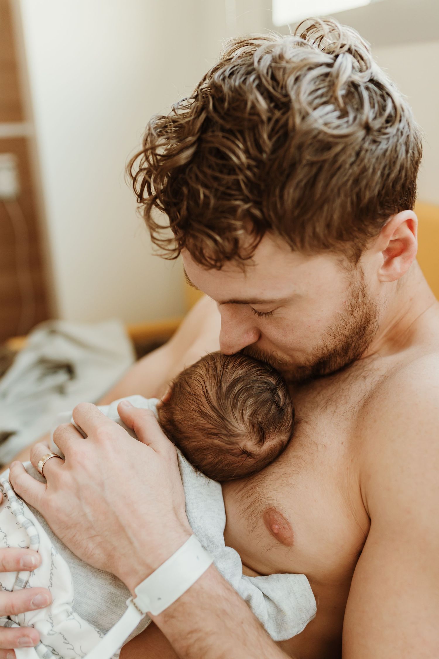 Intimate lifestyle photography capturing tender moment in natural window light.