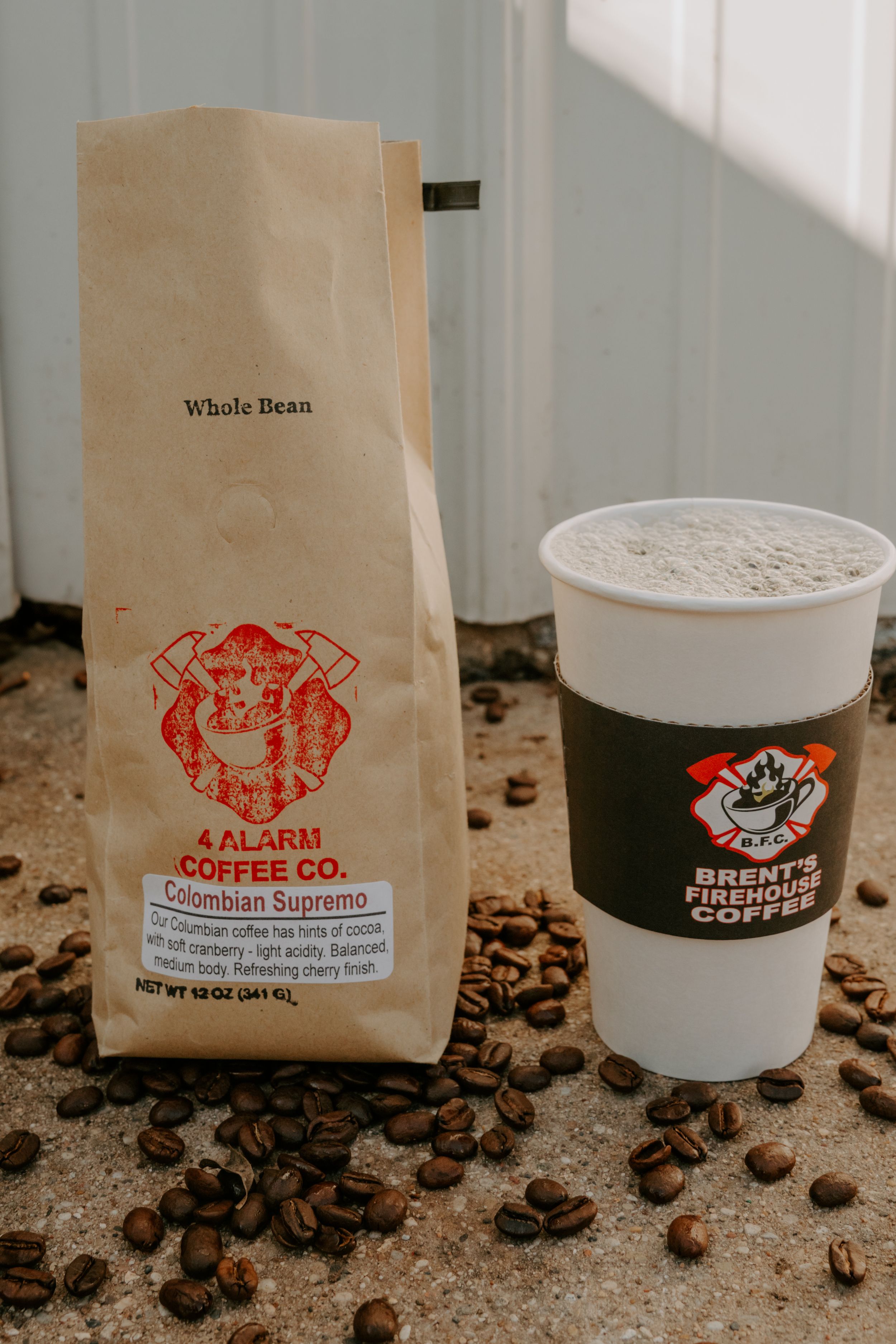 Coffee products and packaging displayed with whole beans on textured surface.