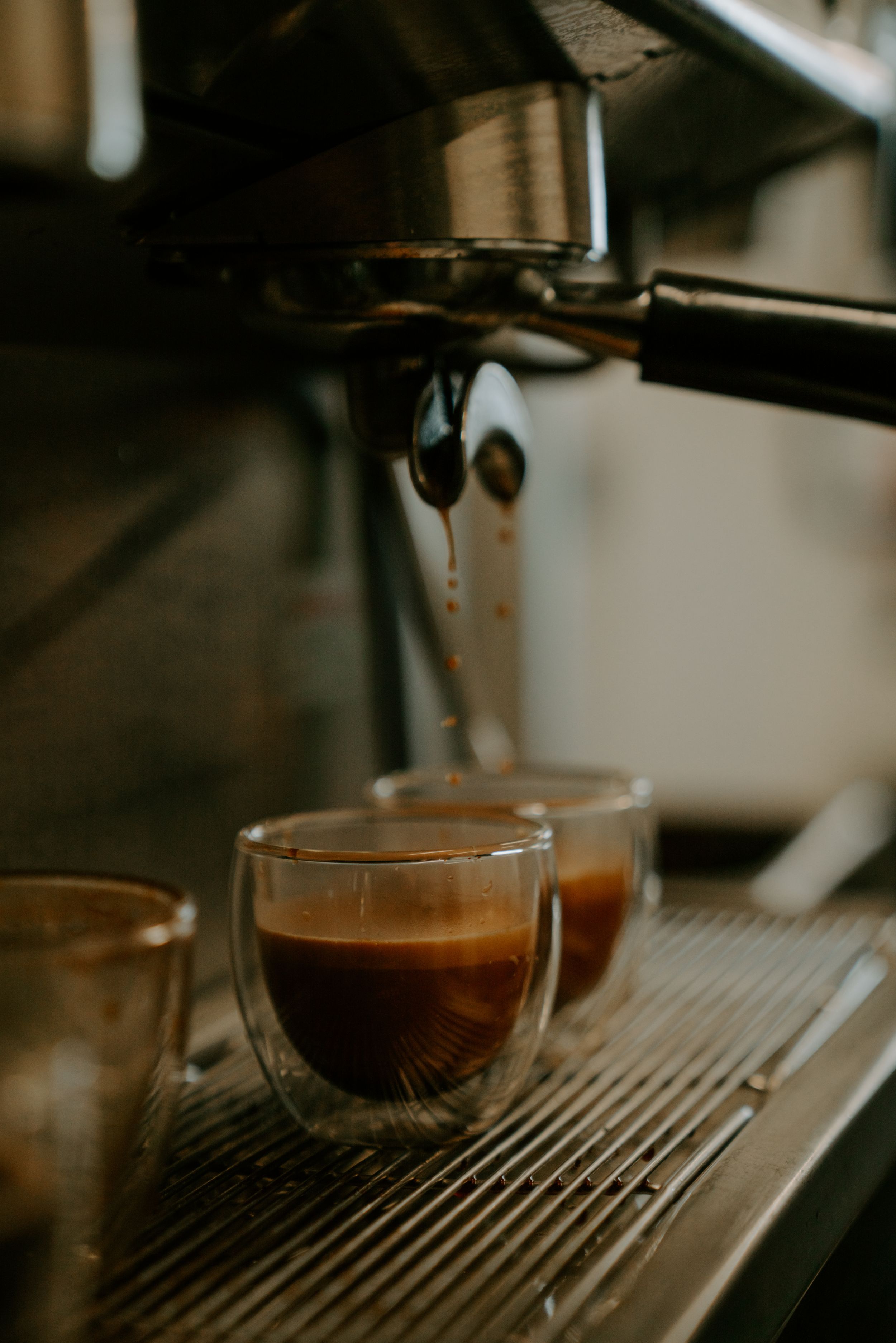 Fresh espresso shots being extracted from a professional coffee machine.