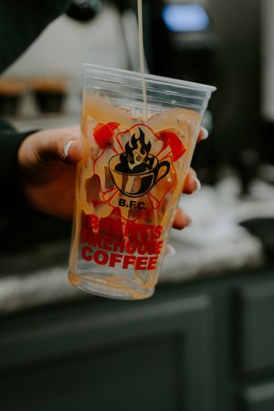 Clear plastic cups with Firehouse Coffee branding and logo displayed.