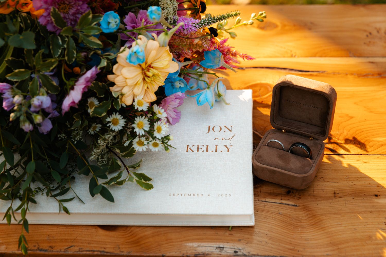 Wedding place cards and floral decorations arranged on a rustic wooden surface with warm lighting. wedding photography st louis