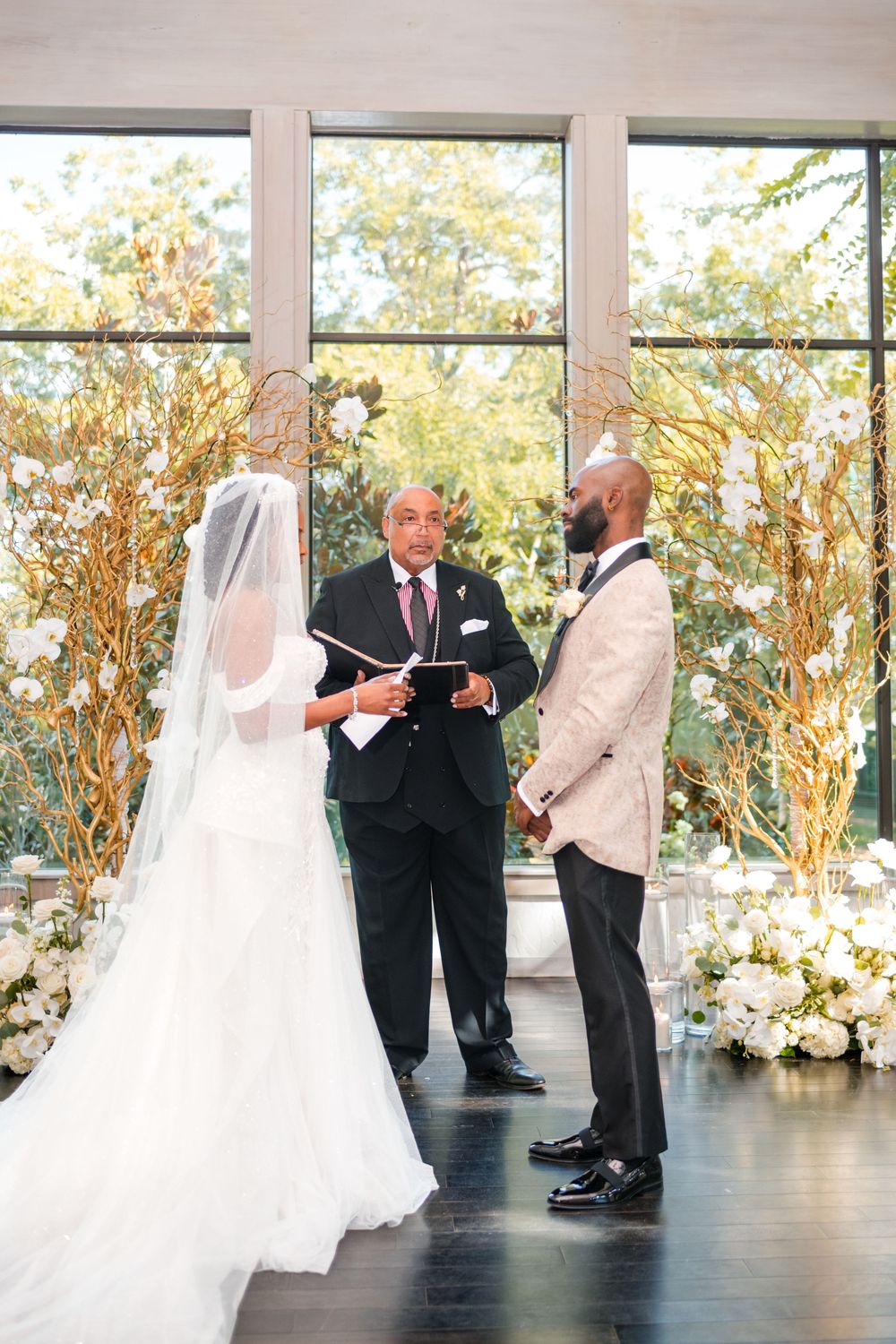A sequence of wedding ceremony moments showing a bride in white gown and veil during the service in a bright glass room.