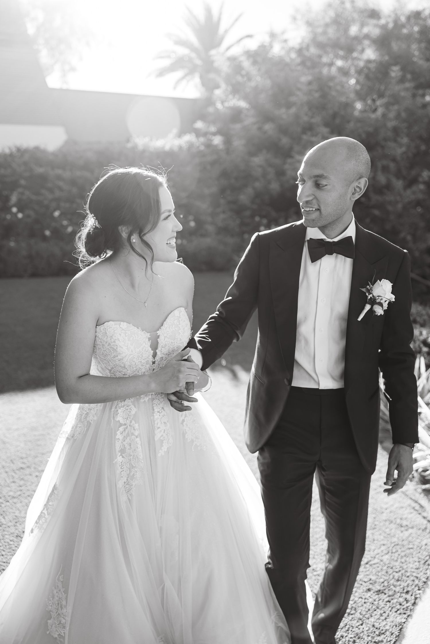 Romantic black and white wedding photos show couple sharing intimate moments in an outdoor garden setting.