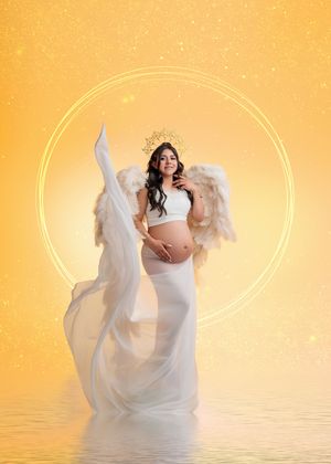 Pregnant woman in white with angel wings and gold crown on glowing yellow celestial background.