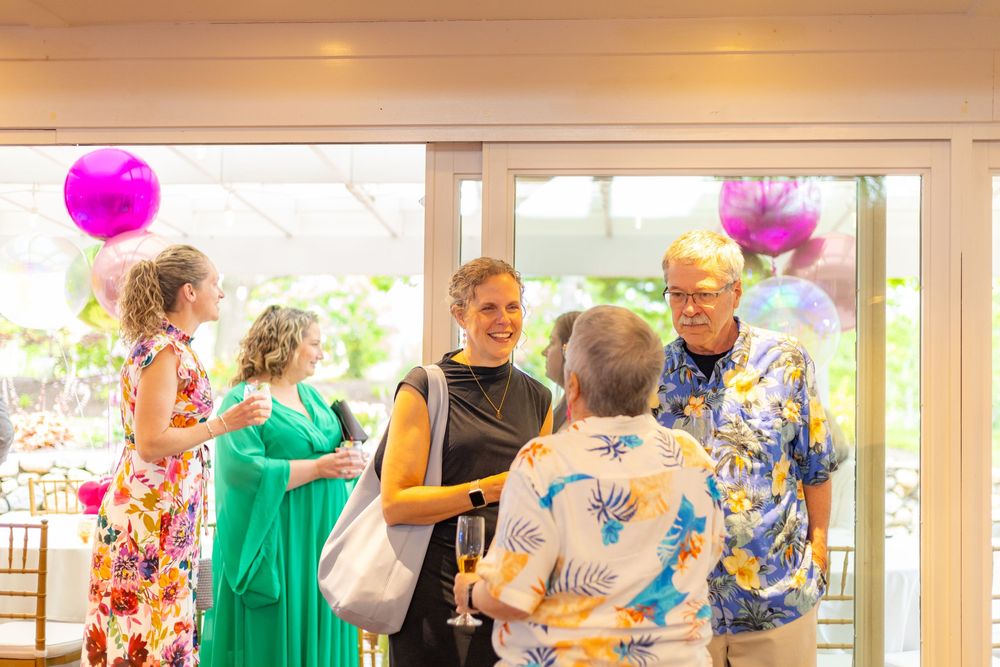 Seniors participate in a lively balloon activity during a recreational therapy session at a nursing home.