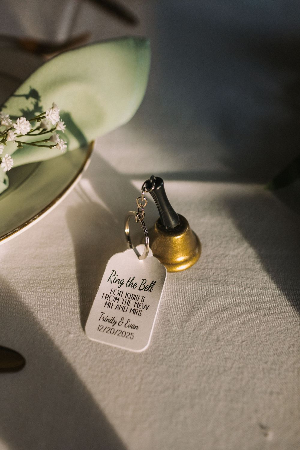 Small wedding favor tags and decorative elements on a textured white surface.