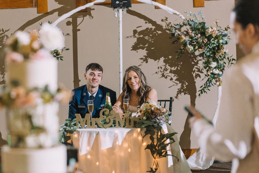 Wedding reception venue decorated with floral arrangements and soft lighting.