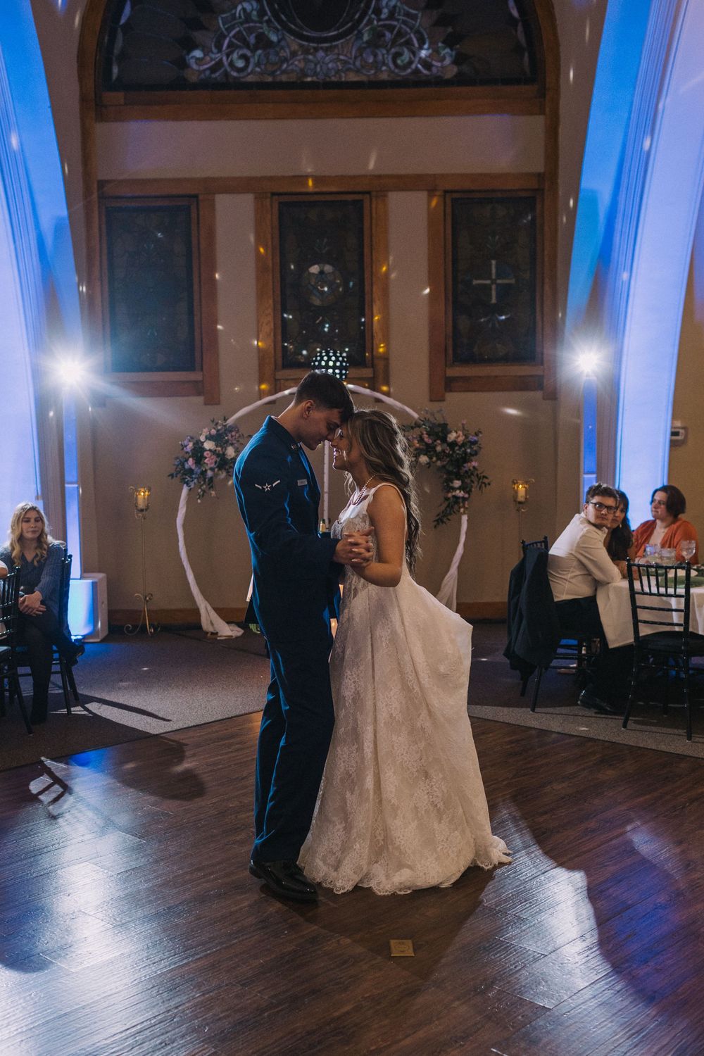 Romantic first dance sequence captured in a beautifully lit ballroom with hardwood floors.