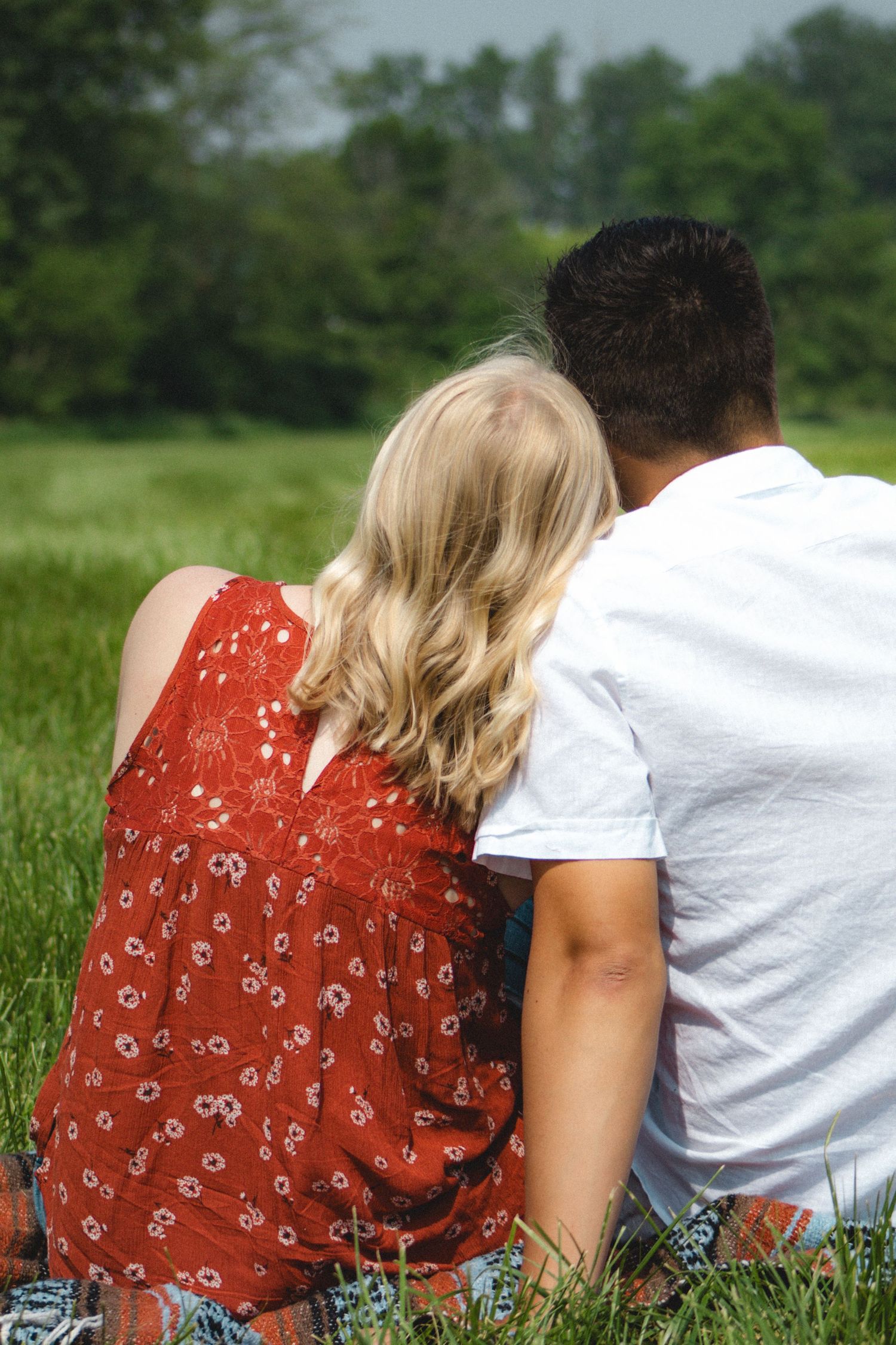 a couple leaning on each other facing away from the camera