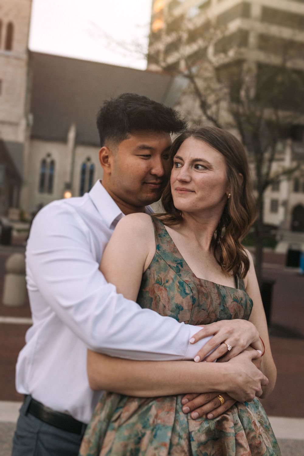 Intimate couple's portrait session showing tender moments against urban architecture.