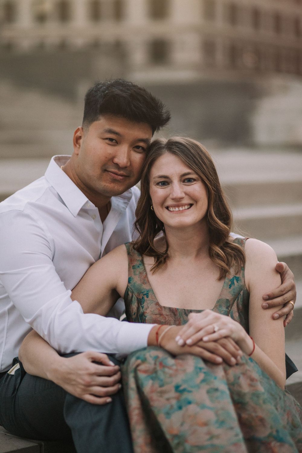 Candid moments of affection captured during urban couple's photography session.