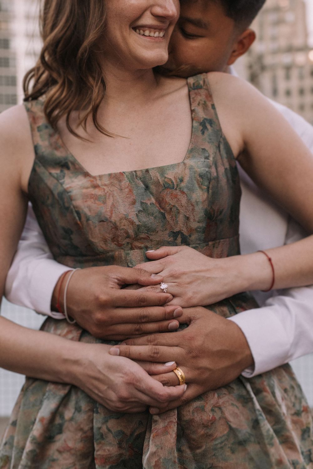 Close-up photo sequence showing hands embracing with a floral dress and white shirt in the background.