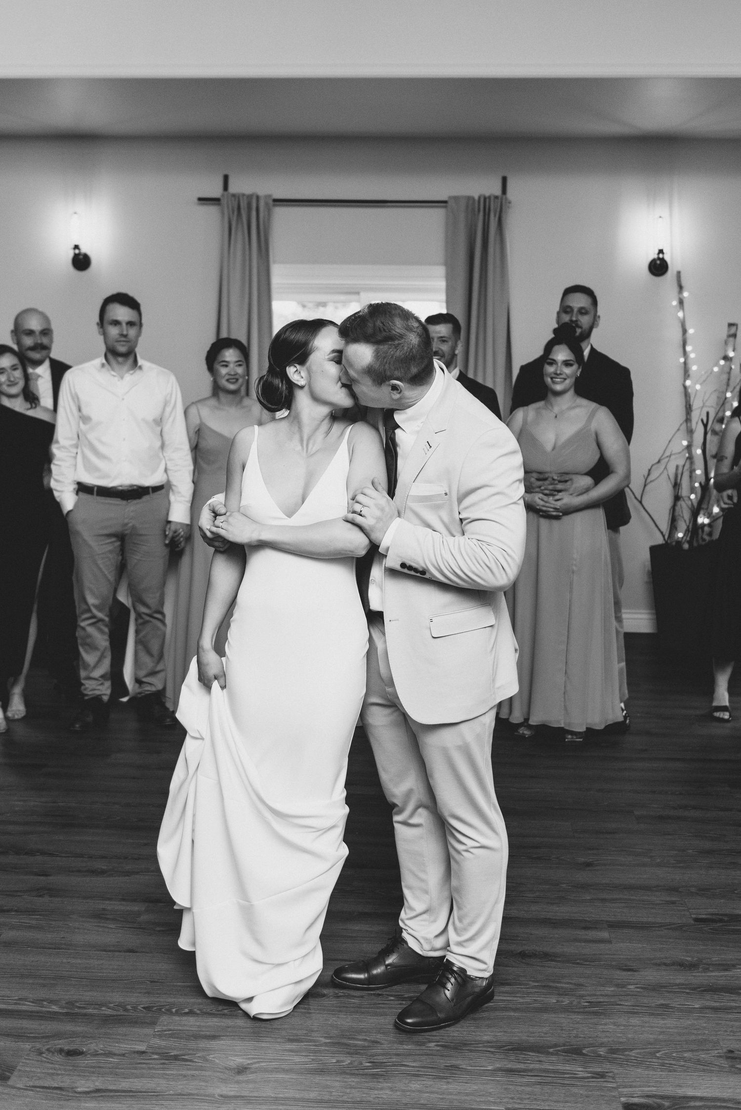 Black and white sequence of wedding couples dancing together on a wooden floor during a reception celebration.