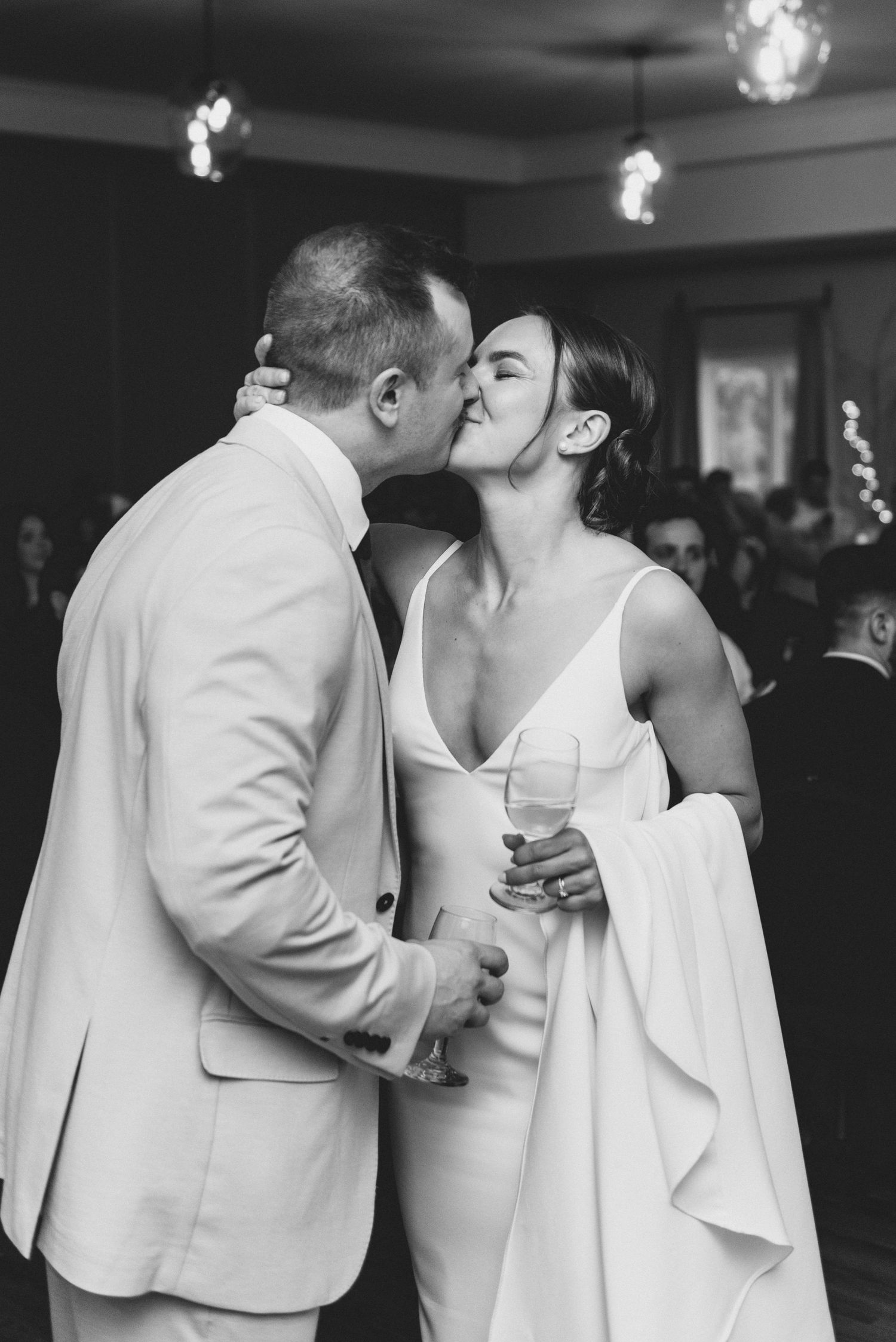 Intimate dance sequence showing tender moments between a couple in white formal attire.
