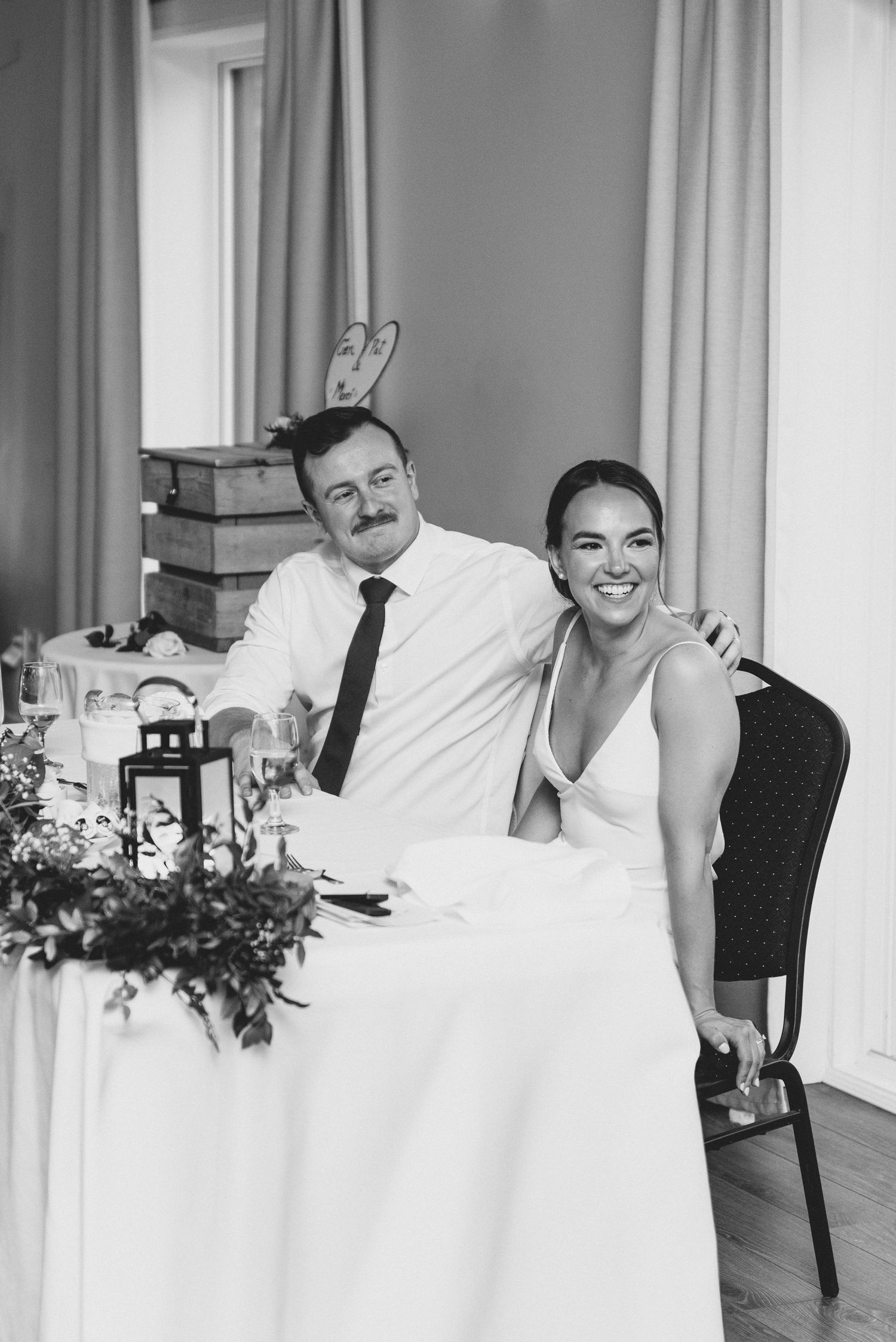 Black and white photo series showing playful poses behind white curtains in an elegant interior setting.