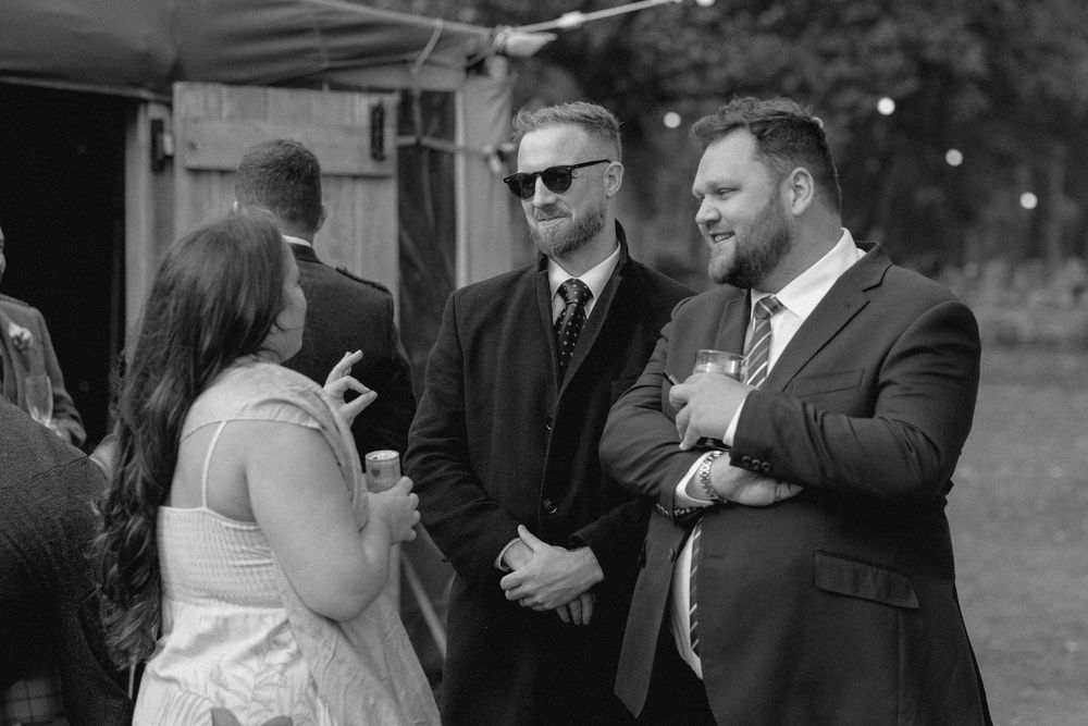 Black and white photo sequence showing candid moments between a bride and groom during their outdoor wedding celebration.