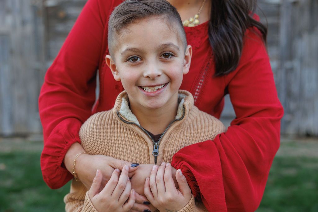 A collection of cropped photos showing people in red sweaters embracing and smiling together outdoors.