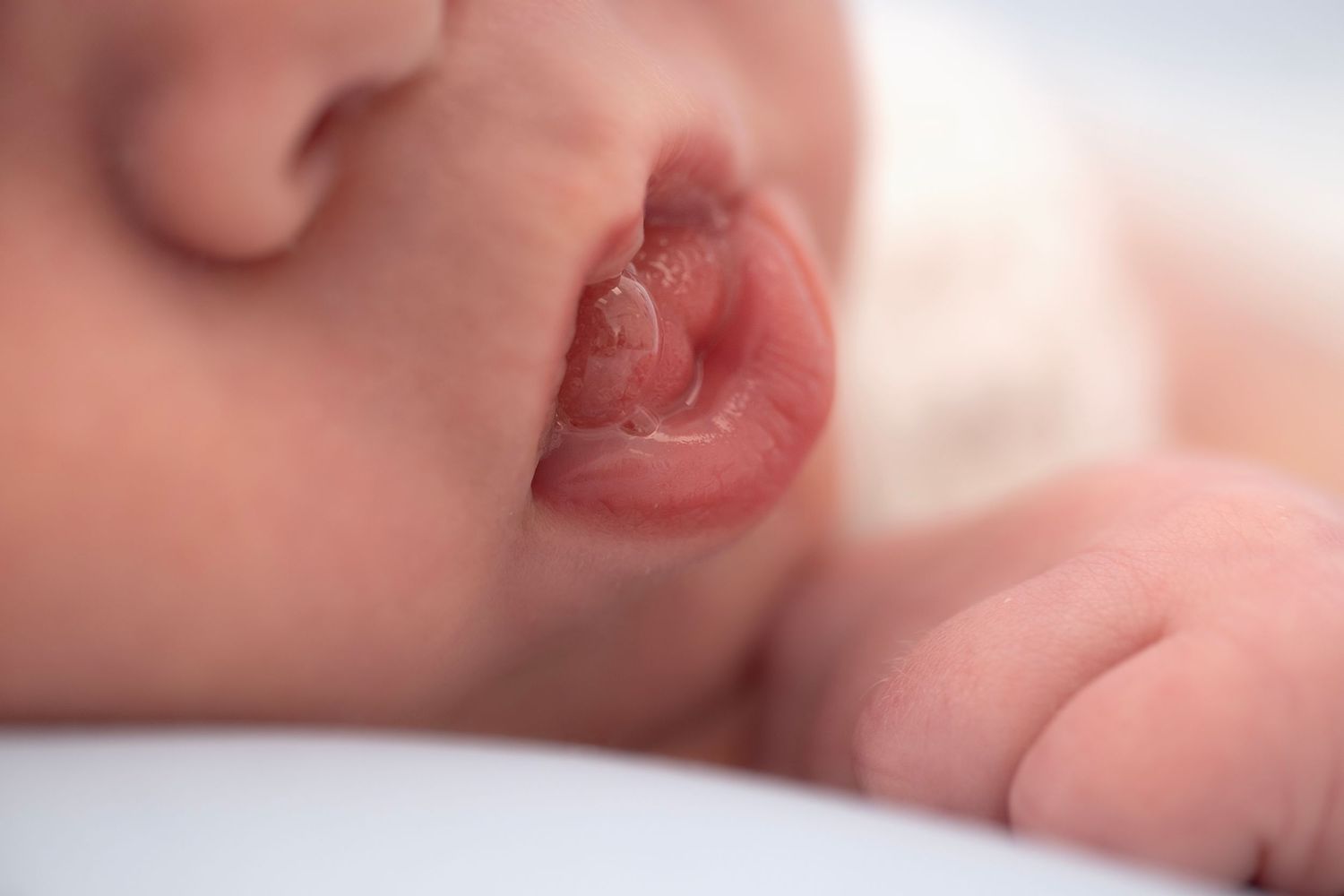Close up macro shot of newborn lips with milk bubble