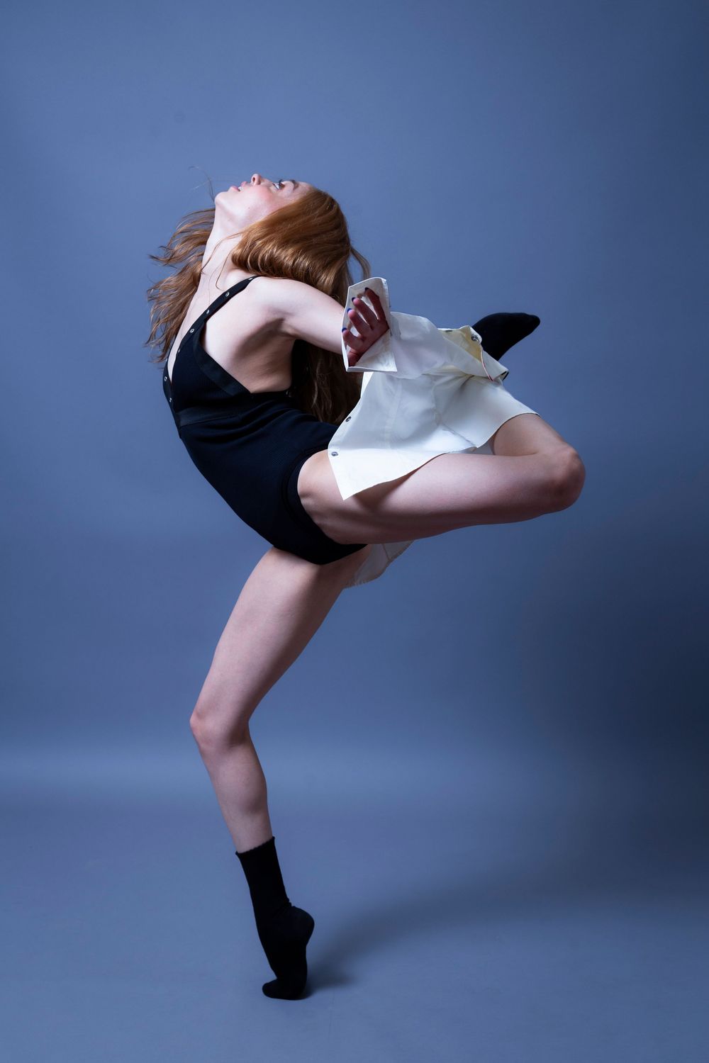 A series of dynamic dance poses showing graceful leg movements against a blue studio backdrop.