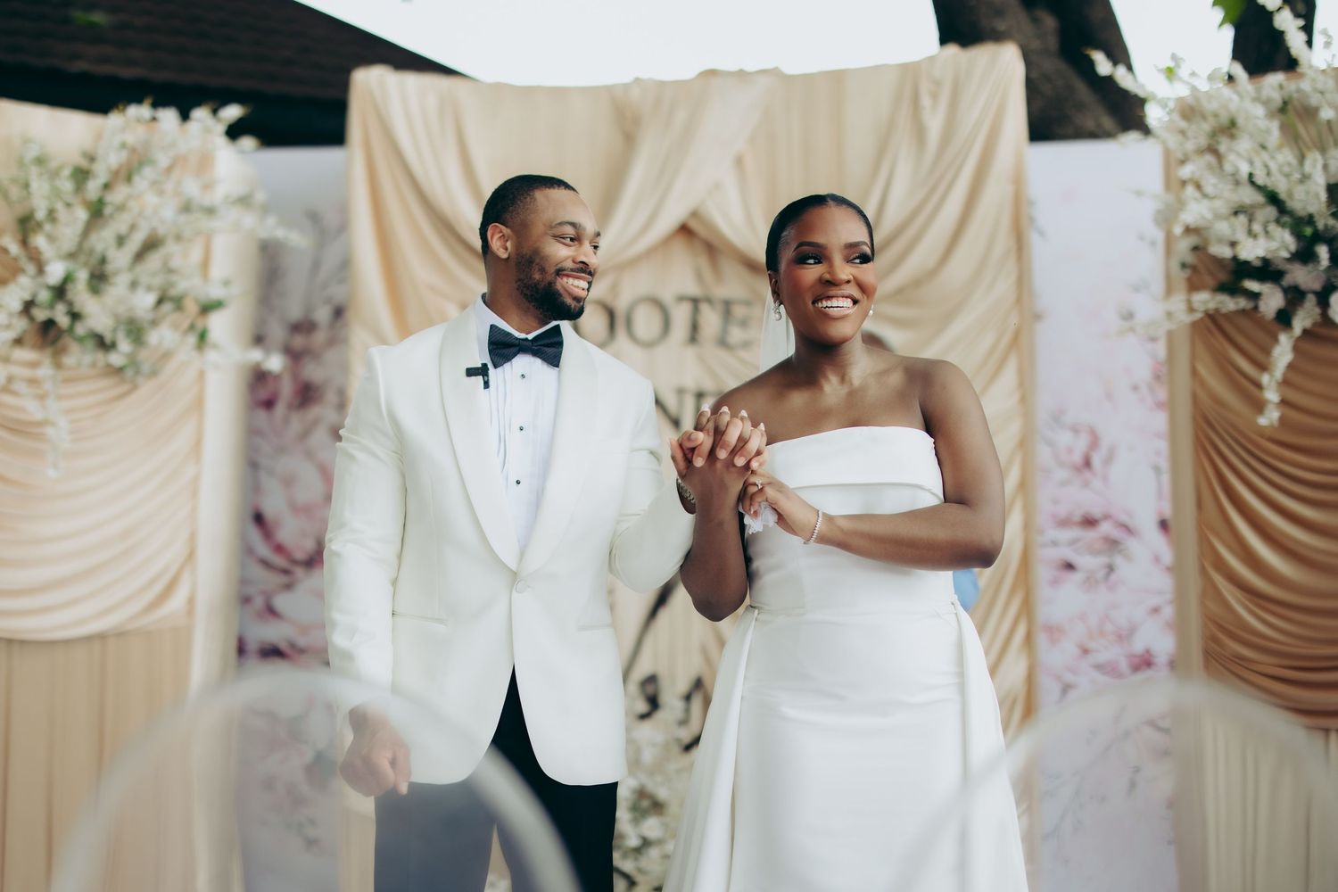A wedding couple poses against a rustic wooden wall in a series of artistic minimalist portraits.