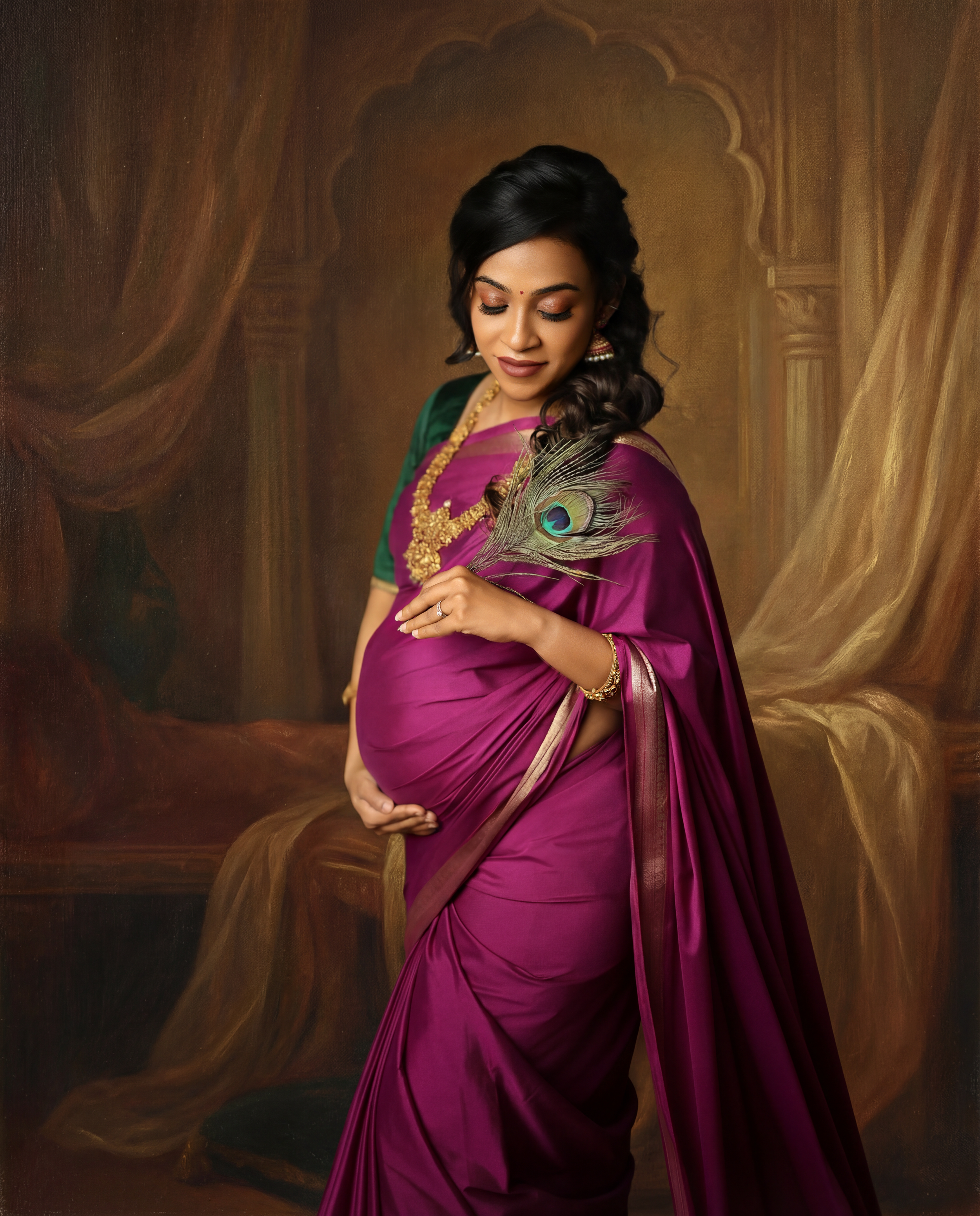 A woman in a flowing magenta dress poses elegantly with a peacock feather in a studio setting.