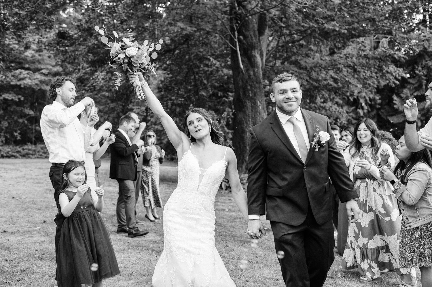bride and groom celebrate getting married in a black and white image
