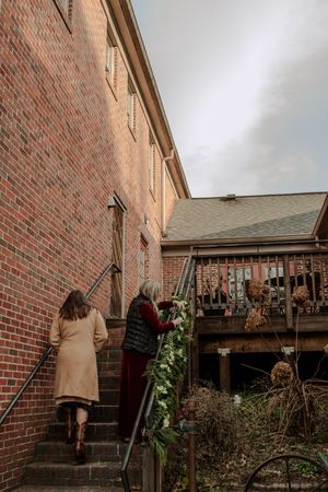 A series of exterior shots showing a brick building with a wooden deck and outdoor decorations.