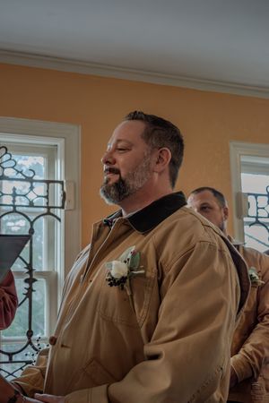 A series of candid moments captured through window panes showing a person in a tan jacket.