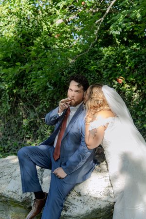 A romantic wedding couple shares intimate moments in a series of outdoor photos against lush greenery.