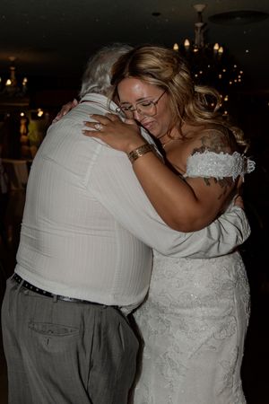 Intimate dance moment captured at a wedding reception with dim lighting and warm ambiance.