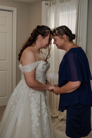 A series of wedding dress fitting moments showing adjustments being made to a white lace gown.