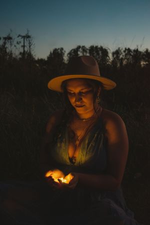 Atmospheric nighttime photos lit by warm firelight create a moody outdoor scene.