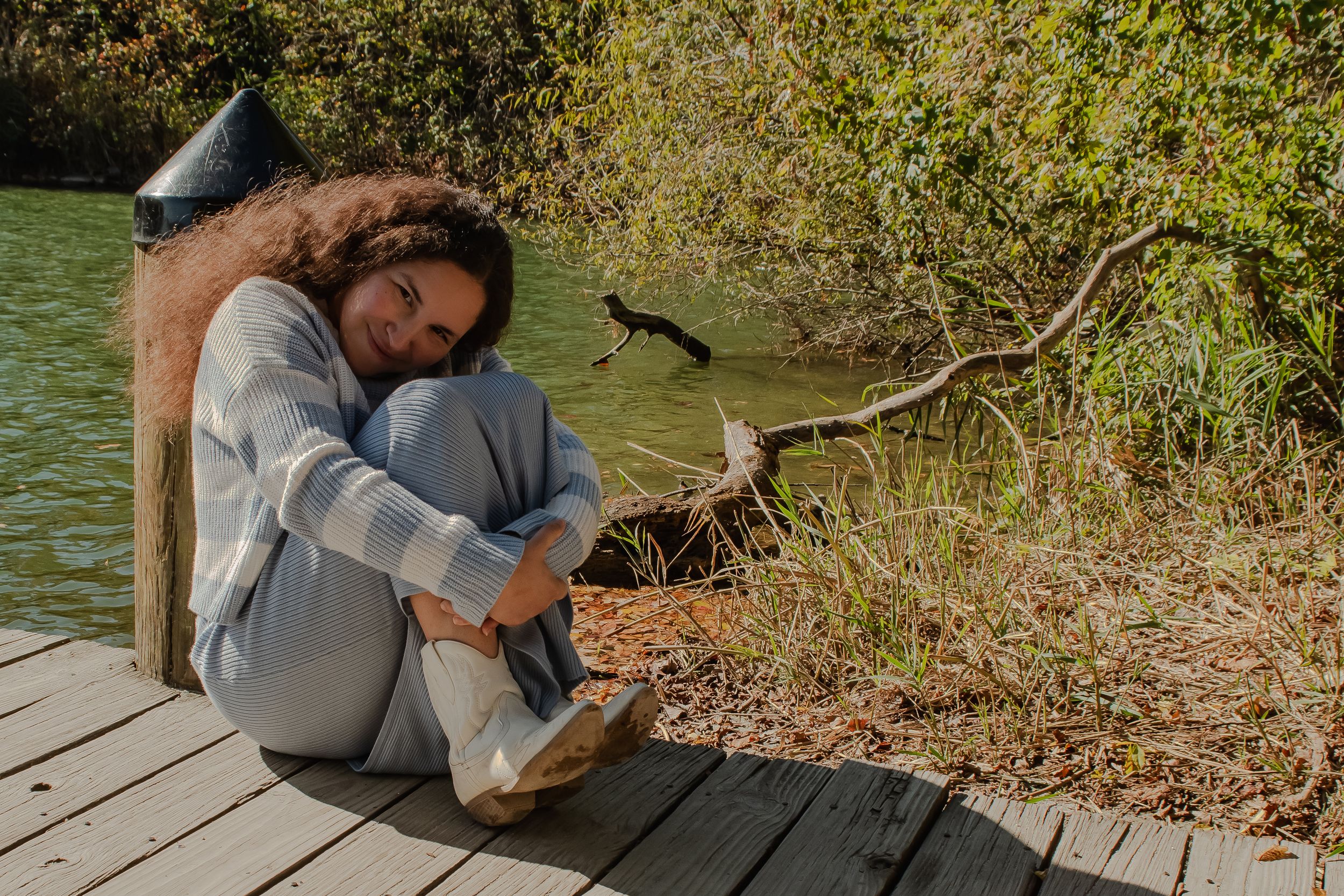 A series of relaxing poses shown in a natural outdoor setting by a dock near water and greenery.